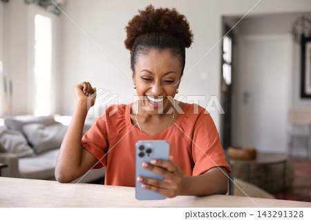 Happy woman celebrates good news received in sms Happy woman celebrates good news received in sms 143291328
