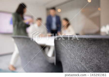 Blurred corporate team discussing business project in office boardroom Blurred corporate team discussing business project in office boardroom 143291361