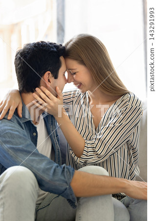 Couple in love touching foreheads and smiling with eyes closed Couple in love touching foreheads and smiling with eyes closed 143291993