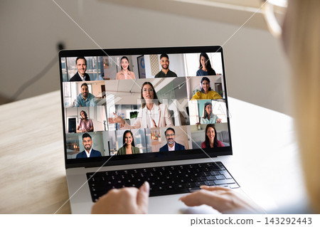 Closeup laptop screen displaying multiethnic businesspeople engaging in video call Closeup laptop screen displaying multiethnic businesspeople engaging in video call 143292443