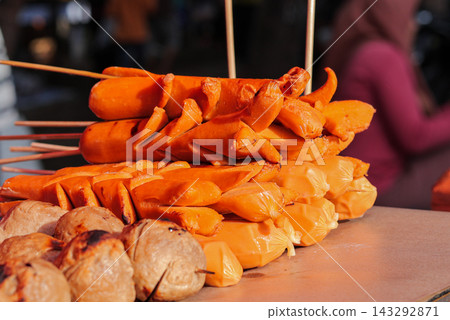 Grilled orange sausages and meatballs on skewers Grilled orange sausages and meatballs on skewers 143292871