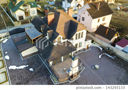 Aerial top view of new residential house cottage with shingle roof on fenced big yard on sunny day Aerial top view of new residential house cottage with shingle roof on fenced big yard on sunny day 143293133