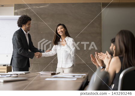 Team leader shake hand of happy teammate before applauding audience Team leader shake hand of happy teammate before applauding audience 143293246