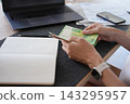 Woman counting cash while planning household budget at home 143295957