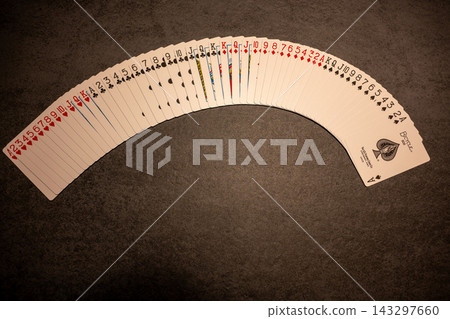 Spread the playing cards on the table. Spread the playing cards on the table. 143297660