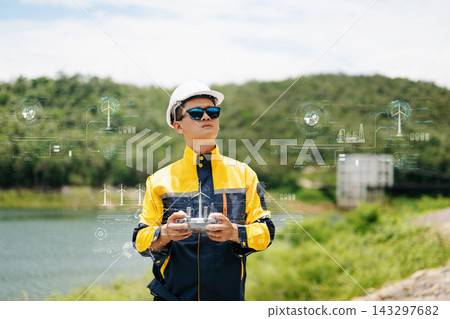 Asian engineer in hardhat landing a drone on his hand near wind turbines for renewable energy site inspection and survey. Asian engineer in hardhat landing a drone on his hand near wind turbines for renewable energy site inspection and survey. 143297682