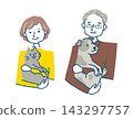 A smiling senior woman holding a cat and a senior man holding a dog. 143297757