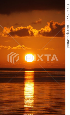 The sunset paints the sea and sky orange. The sunset paints the sea and sky orange. 143298525