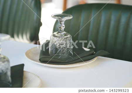 Table setting with glass and napkin at a restaurant Table setting with glass and napkin at a restaurant 143299323