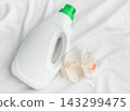Laundry detergent bottle with orchid on white fabric 143299475