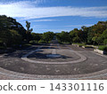 A park square with a circular paving pattern. 143301116