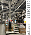 A store space with high ceilings and expansive product shelves. 143301520