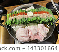 A pot full of ingredients brought to the table 143301664