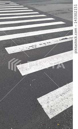 Pedestrian Crosswalk Markings on Asphalt Road with Urban Street Perspective Pedestrian Crosswalk Markings on Asphalt Road with Urban Street Perspective 143302151