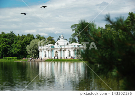 Classical Pavilion Reflected in Lake with Flying Birds in Historic Park Classical Pavilion Reflected in Lake with Flying Birds in Historic Park 143302186