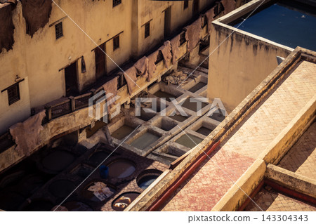 Elevated view of dye vats at the historic Chouara Tannery in Fes Elevated view of dye vats at the historic Chouara Tannery in Fes 143304343