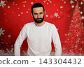 Serious man looking at camera on Christmas background 143304432