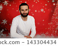Friendly bearded man sitting on Christmas background 143304434