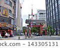 A tower visible beyond the large gate standing on the approach to the temple. 143305131