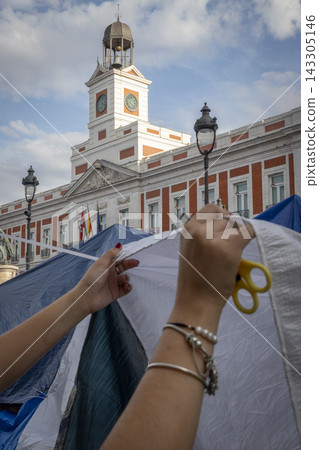 Temporary encampment in Puerta del Sol Madrid with tents tarps signs and temporary structures set up in the central square Temporary encampment in Puerta del Sol Madrid with tents tarps signs and temporary structures set up in the central square 143305146
