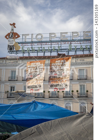 Temporary encampment in Puerta del Sol Madrid with tents tarps signs and temporary structures set up in the central square Temporary encampment in Puerta del Sol Madrid with tents tarps signs and temporary structures set up in the central square 143305169