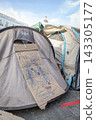 Temporary encampment in Puerta del Sol Madrid with tents tarps signs and temporary structures set up in the central square 143305177