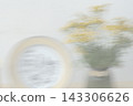 Blurred summer still life background with yellow flowers and a plate 143306626