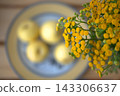 Medicinal plant yellow tansy against the background of a plate with peaches 143306637