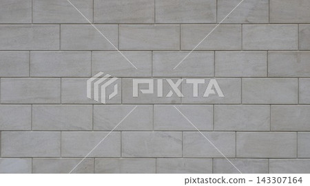 Texture of modern masonry made of rectangular blocks. Smooth, light-gray wall background with fine joints. Minimalist seamless pattern. Light, polished Dagestani stone used in construction. Texture of modern masonry made of rectangular blocks. Smooth, light-gray wall background with fine joints. Minimalist seamless pattern. Light, polished Dagestani stone used in construction. 143307164