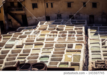 Elevated view of dye vats at the historic Chouara Tannery in Fes Elevated view of dye vats at the historic Chouara Tannery in Fes 143307745