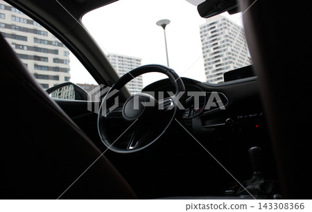 Cityscape is Visible through Windshield of New Car Near Modern Buildings Cityscape is Visible through Windshield of New Car Near Modern Buildings 143308366