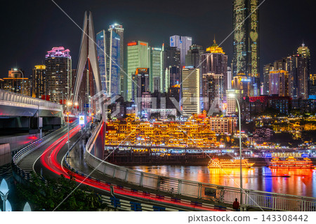Chongqing, China: Hongyadong and Qianlimen Bridge, a dazzling night view woven from the light trails of cars. Chongqing, China: Hongyadong and Qianlimen Bridge, a dazzling night view woven from the light trails of cars. 143308442