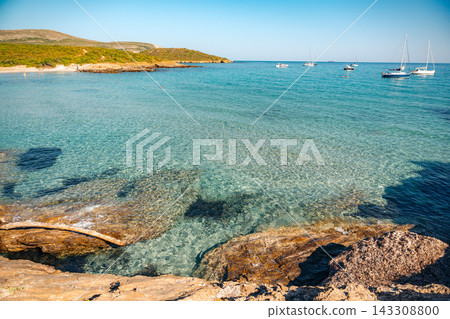 Rugged rocky cliffs overlook crystal clear blue water along the coast of North Corsica France Rugged rocky cliffs overlook crystal clear blue water along the coast of North Corsica France 143308800