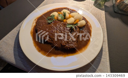Traditional croatian pasticada beef stew with potato gnocchi 143309469