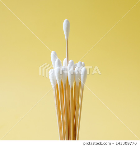 wood swabs or Cotton swabs on a color background. wood swabs or Cotton swabs on a color background. 143309770