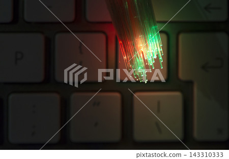 Fiber Optic Cables Glowing Over Computer Keyboard Fiber Optic Cables Glowing Over Computer Keyboard 143310333