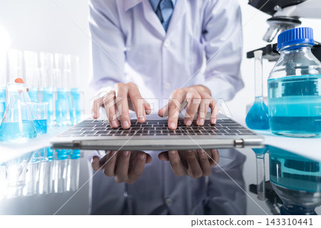 Scientist Typing on Laptop in Modern Laboratory Scientist Typing on Laptop in Modern Laboratory 143310441