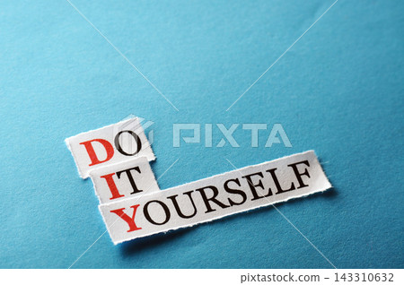 DIY Do It Yourself Paper Text on Blue Background 143310632