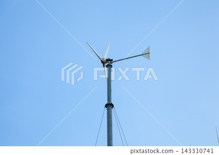 Wind Turbine on Pole Against Clear Blue Sky Wind Turbine on Pole Against Clear Blue Sky 143310741