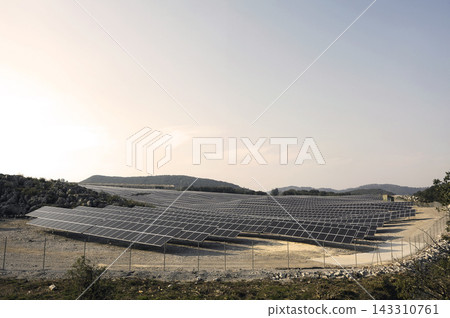 Solar Farm Panels in Rural Landscape at Sunset Solar Farm Panels in Rural Landscape at Sunset 143310761