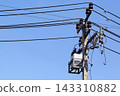 Electric Power Lines and Utility Pole Against Blue Sky 143310882