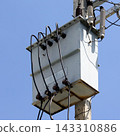 Power Transformer on Utility Pole Against Blue Sky 143310886