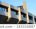 Modern Concrete Building Facade with Geometric Windows and Blue Sky 143310887