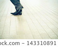 Business Shoes Walking on Bright Tiled Floor with Copy Space 143310891