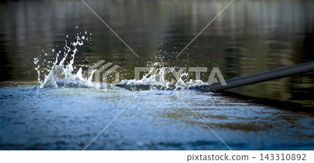 Rowing Oar Splashing Water in Dynamic Outdoor Sports Scene Rowing Oar Splashing Water in Dynamic Outdoor Sports Scene 143310892
