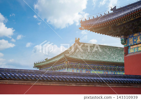 Traditional Chinese Architecture with Ornate Roof and Red Wall Under Blue Sky Traditional Chinese Architecture with Ornate Roof and Red Wall Under Blue Sky 143310939