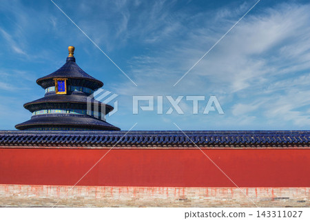 The Temple of Heaven in Beijing, China, with its iconic blue tiled roof and red wall under a clear blue sky. The Temple of Heaven in Beijing, China, with its iconic blue tiled roof and red wall under a clear blue sky. 143311027