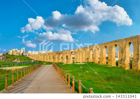Ancient Kamares Aqueduct in Larnaca, Cyprus under a Blue Sky Ancient Kamares Aqueduct in Larnaca, Cyprus under a Blue Sky 143311041