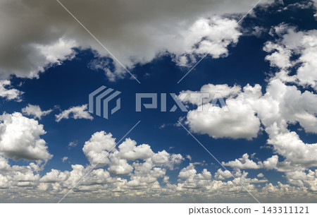 Bright landscape of blue sky with flying white clouds. Colorful summer skyscape Bright landscape of blue sky with flying white clouds. Colorful summer skyscape 143311121