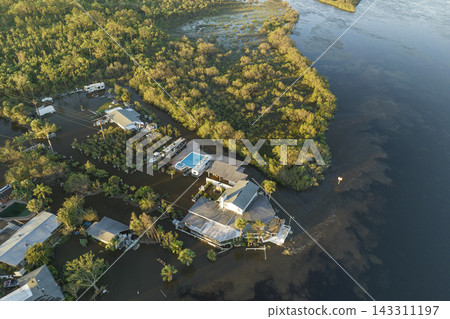 Aftermath of natural disaster. Flooded houses by hurricane Ian rainfall in Florida residential area Aftermath of natural disaster. Flooded houses by hurricane Ian rainfall in Florida residential area 143311197